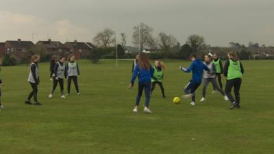 Northern Ireland football internationals Kirsty and Caitlin McGuinness returned to their old school St Genevieve's to help train potential stars of the future.