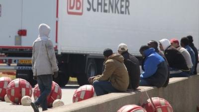 Migrants on the main road into Calais ferry port where some have been trying to board UK bound lorries.