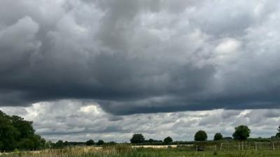 Shower clouds over green fields