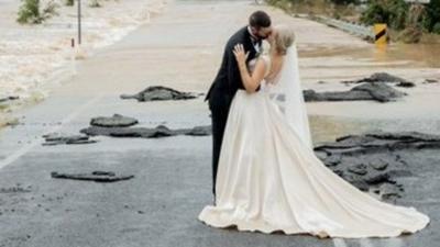 An Australia bride had to be airlifted to her wedding after discovering her family home had been cut off by floods overnight.