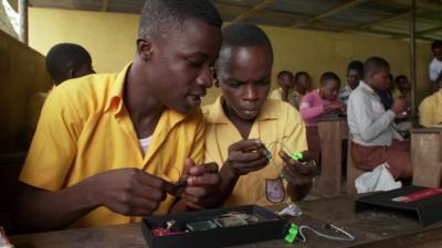 Students using the science kit which contains lots of science equipment including wires and batteries