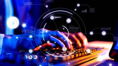 Hands on a laptop with graphical representations of AI