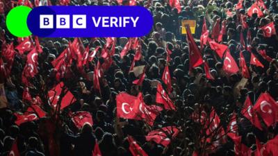 A BBC Verify logo appears over a photo showing a crowd of people waving Turkish flags.