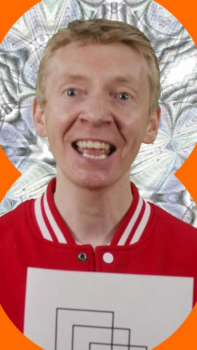 Presenter James Grime holding up a puzzle with three squares on it