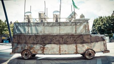 "Battle Bus" a sculpture of a bus with oil drums by Nigerian artist Sokari Douglas Camp