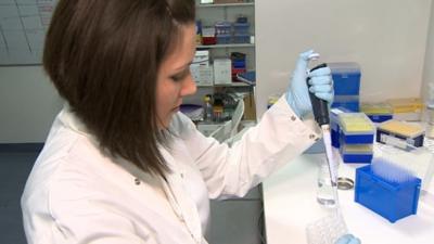 researcher at Swansea University testing cells