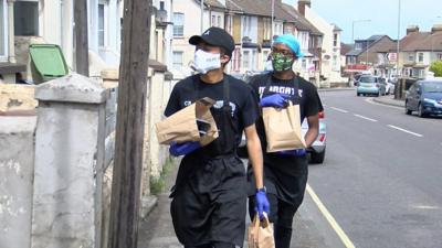 Charity workers delivering food parcels