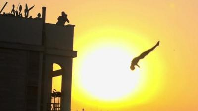 A cliff diver in action