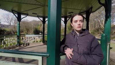 Girl standing in bandstand in park