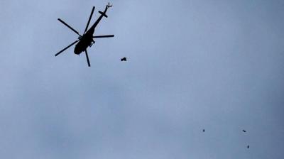 Syrian helicopter dropping bombs