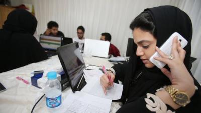 Members of the communication staff for the campagin of a female candiate for the upcoming Saudi municipal elections work hard on contacting and talking to electors