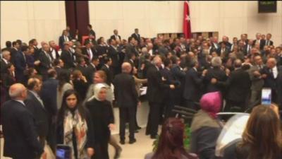 MPs fighting in Turkish parliament.