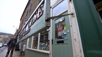 This shop sign protects a store from flooding