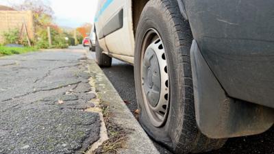 Car with vandalised tyre in Halstead, Essex