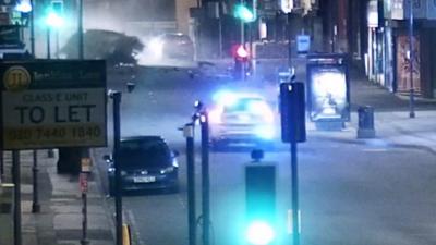 Crashed car which has rolled onto the road after colliding into a shop