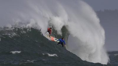 Ken Collins, left, and Chris Bertish surf a giant wave during the second heat of the Mavericks surfing contest on 12 February 2016, in Half Moon Bay, Calif.