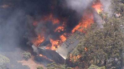 A house alight in the bushfire north of Perth