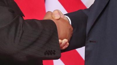 Close up of handshake between Trump and Kim