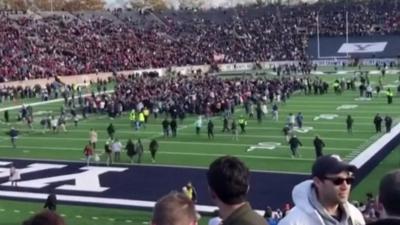 Protesters on the football pitch of a Harvard-Yale game