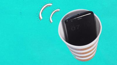 A smartphone in a paper cup