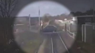 A man drove his car over the Felixstowe to Ipswich line despite lights warning of an approaching train.