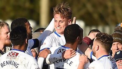 Mansfield players celebrate with Danny Rose