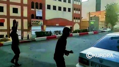 Two men standing in a road in Iran