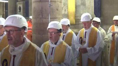 Priests in hard hats