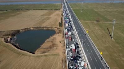 Aerial shot of hundreds of cars piled up on road