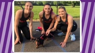 England netballers with a sausage dog