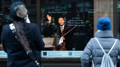 Musician behind glass