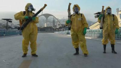 Rio municipals worker who spray insecticide at the Sambadrome in Rio.