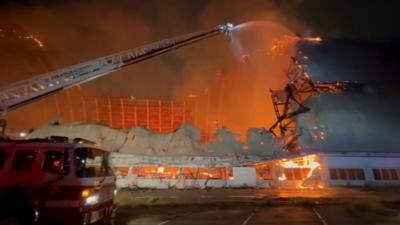 Fire seen raging through remnants of hangar