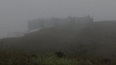 Fog nets stretched across a mountain shrouded in fog