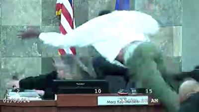 Man mid-air, jumping over court bench