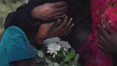 Child grieving at graveside