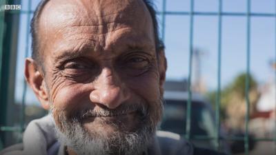 Street hawker smiling at camera