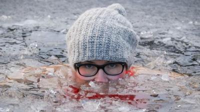 Woman swimming in cold water