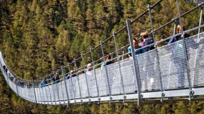 Walkers cross hanging bridge