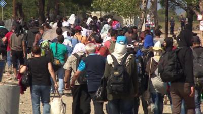 People walking near the the Greece-Macedonia border