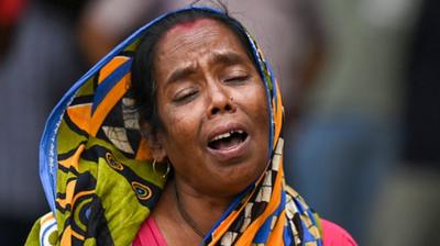 A victim's family member weeps at a business park used as temporary mortuary to identify the dead recovered from the carriage wreckage of a three-train collision near Balasore, in India's eastern state of Odisha,