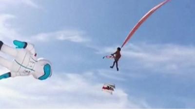 Girl lifted up by kite