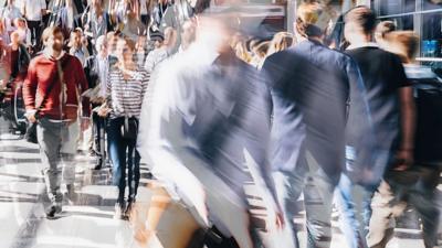 A partially defocused image of a crowd of people walking