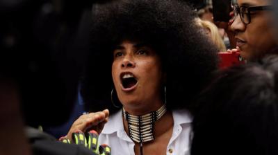 Lili Bernard is confronted by supporters of Bill Cosby outside the courthouse where his trial is held.