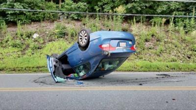 Car flipped over on road