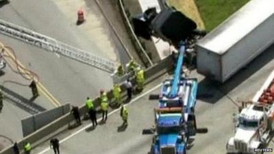 Aerial view of truck dangling from bridge in Michigan