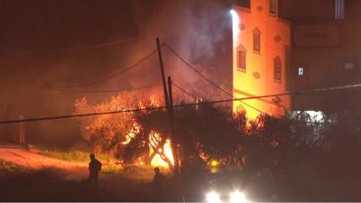 Fire smouldering in front of building