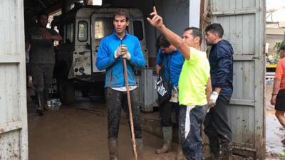 Rafael Nadal helping clear up