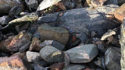 A Manx stone cross in the rubble