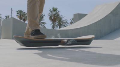 A foot stepping onto a floating hoverboard